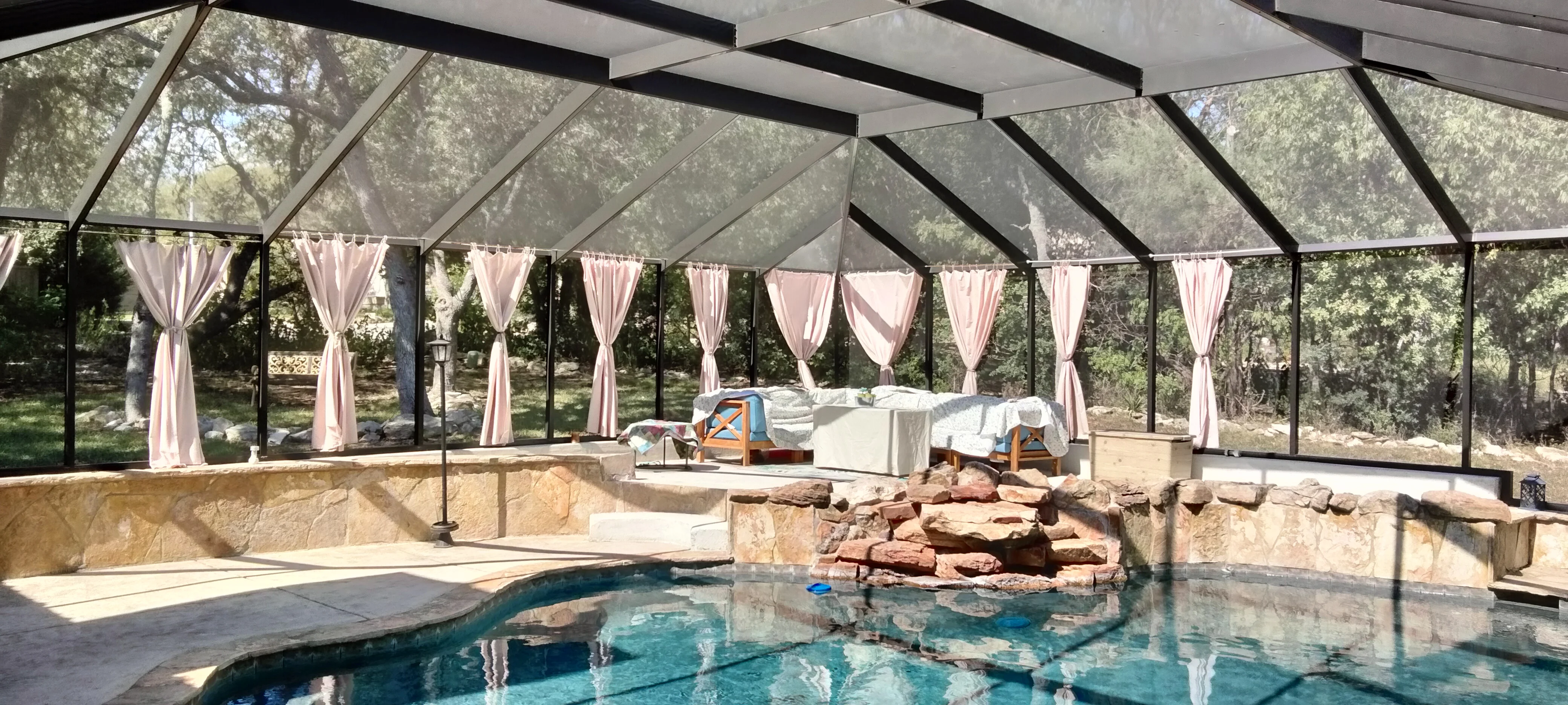 Screened pool enclosure protecting swimming pool