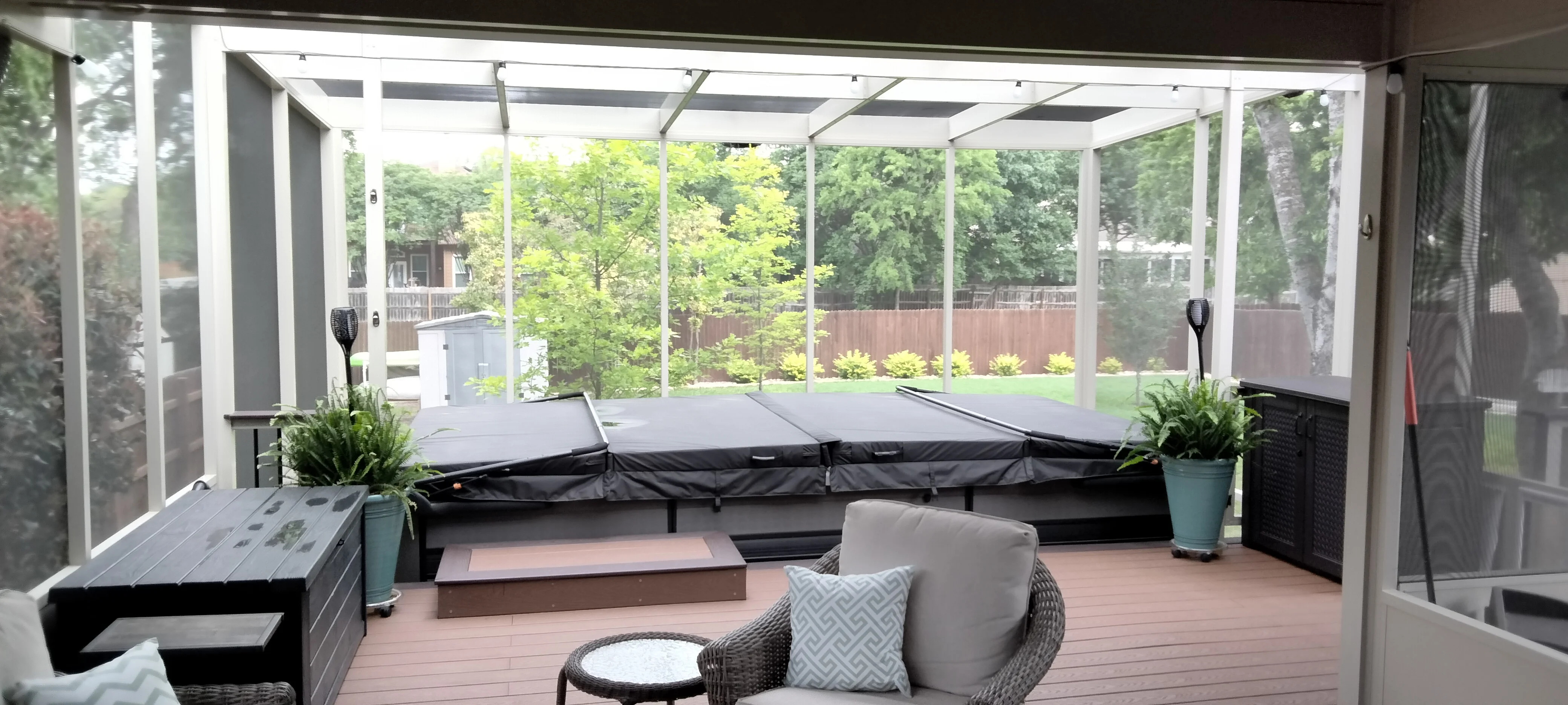 Screened patio with white aluminum frame, composite deck, louvered roof, and built-in seating